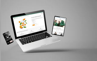 Floating laptop, tablet, and smartphone displaying modern web design on grey background